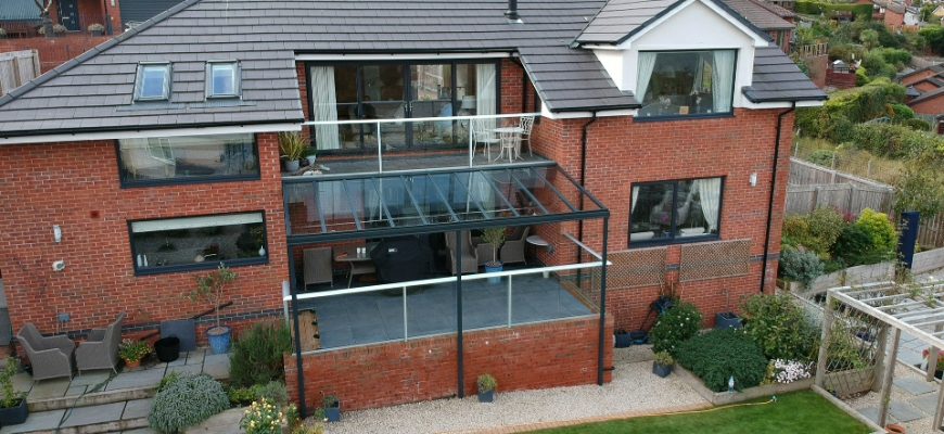 Glass veranda installed over a balcony in north wales by dencas of chester